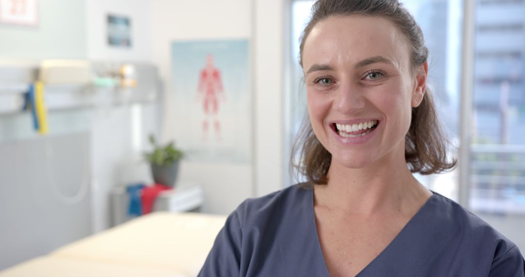 Smiling Female Nurse in Hospital Room Wearing Blue Scrubs - Free Images, Stock Photos and Pictures on Pikwizard.com