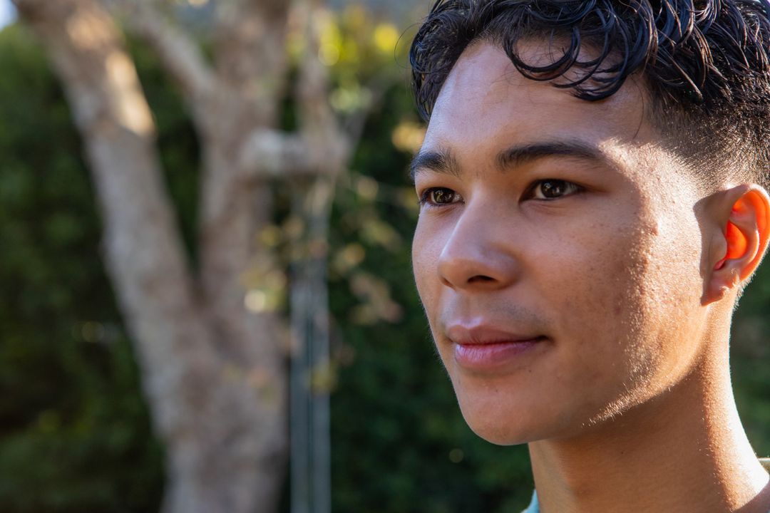 Young Man Reflecting in Sunlit Garden