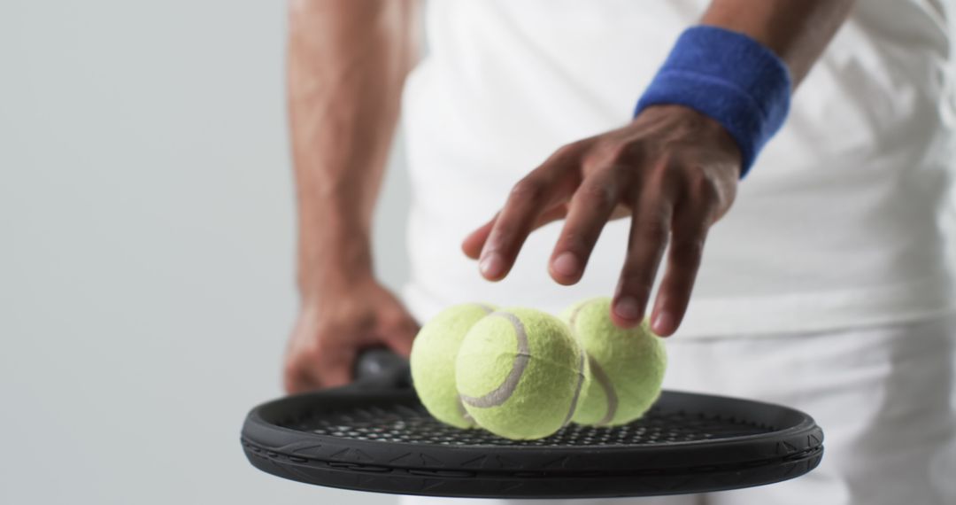 Athlete Balancing Tennis Balls on Racket, Focus on Skill and Precision