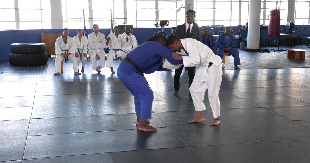 Martial Arts Training with Gis in Gym Setting