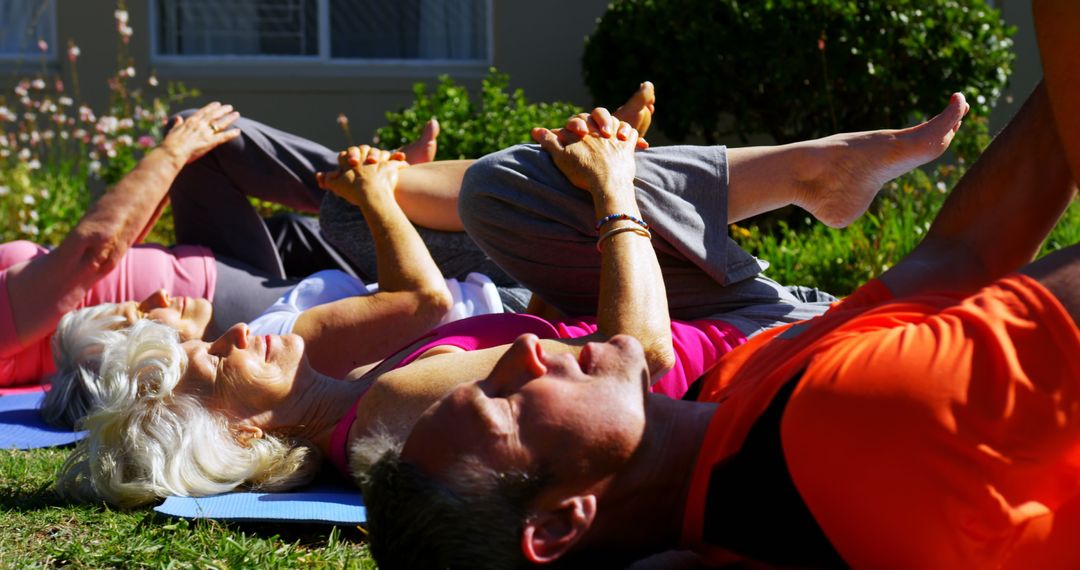 Senior Group Exercising with Trainer in Nursing Home Garden