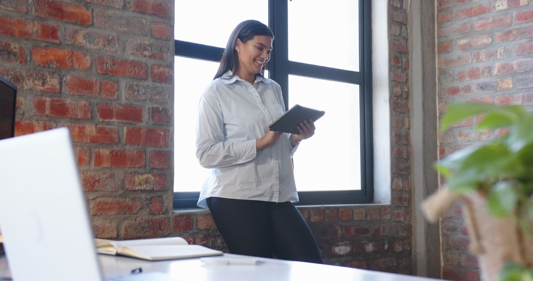 Confident Businesswoman Interacting with Digital Tablet in Modern Office