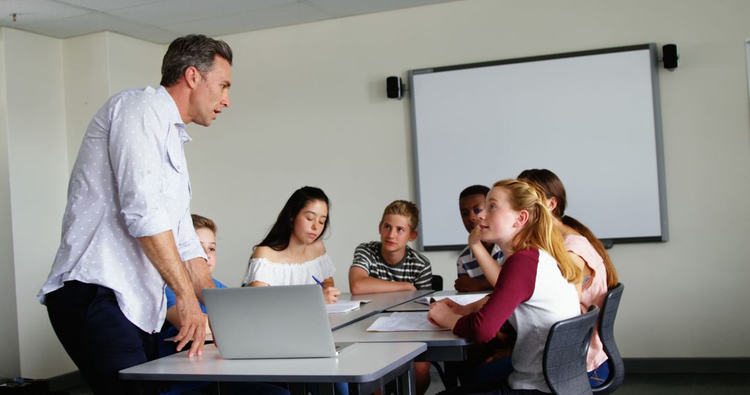 Teacher Guiding Middle School Students in Classroom Discussion - Free Images, Stock Photos and Pictures on Pikwizard.com