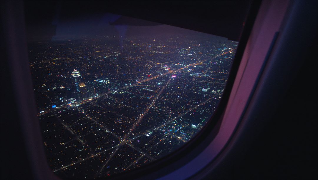 Aerial Cityscape Illuminated by Grid Lights Viewed from Plane