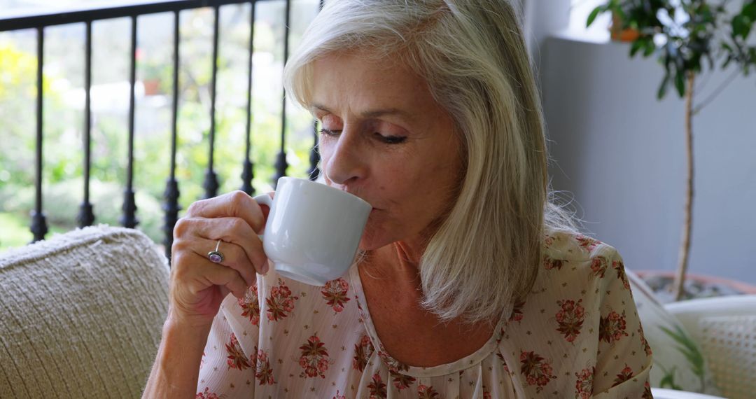 A senior Caucasian woman enjoys a cup of coffee in a cozy home environment, with copy space - Free Images, Stock Photos and Pictures on Pikwizard.com