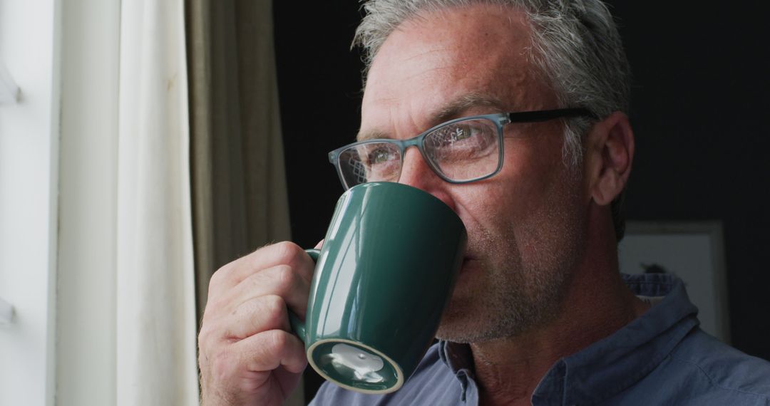 Older Man Enjoying Coffee by Window in Casual Wear - Free Images, Stock Photos and Pictures on Pikwizard.com