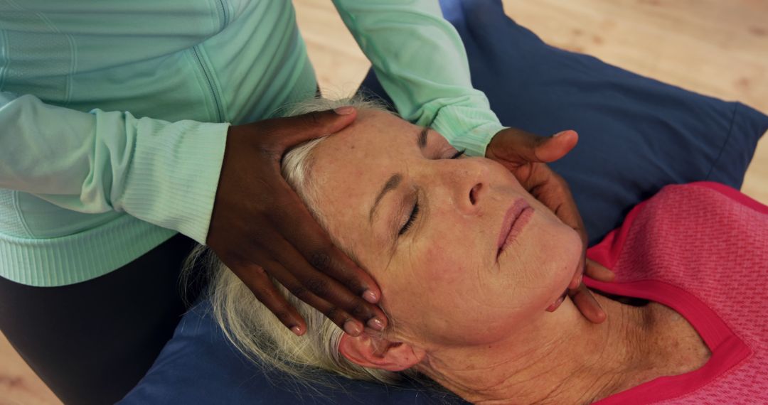 Multiracial Hands Giving Healing Face Massage to Relaxed Senior Woman - Free Images, Stock Photos and Pictures on Pikwizard.com