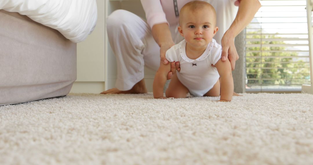 Baby Learning to Crawl on Carpet with Parental Support - Free Images, Stock Photos and Pictures on Pikwizard.com