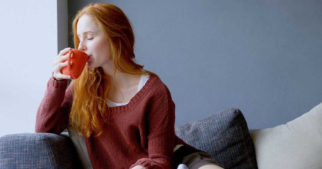 Woman Relaxing with Coffee on Cozy Sofa - Free Images, Stock Photos and Pictures on Pikwizard.com