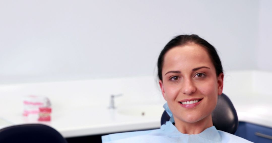 Smiling Woman Wearing Dental Bib in Dentist Office - Free Images, Stock Photos and Pictures on Pikwizard.com