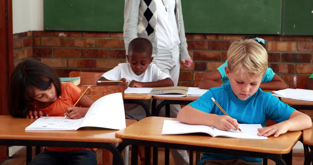 Multiracial kids studying together in classroom - Free Images, Stock Photos and Pictures on Pikwizard.com