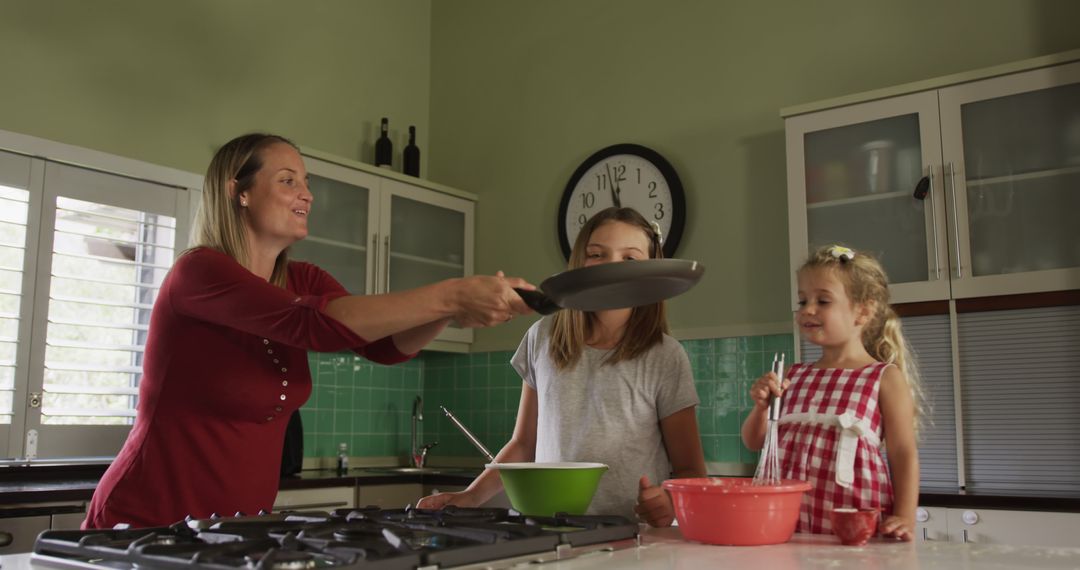 Mother Teaching Daughters to Cook in Bright Kitchen - Free Images, Stock Photos and Pictures on Pikwizard.com