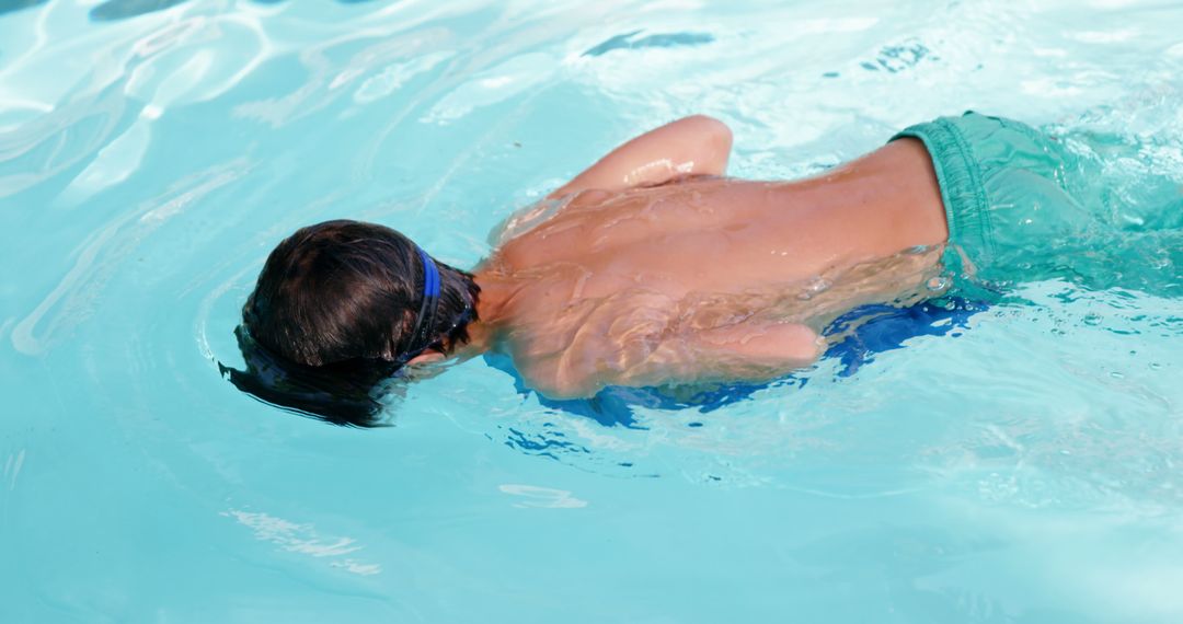 Child Swimming Underwater in Pool on Sunny Day - Free Images, Stock Photos and Pictures on Pikwizard.com