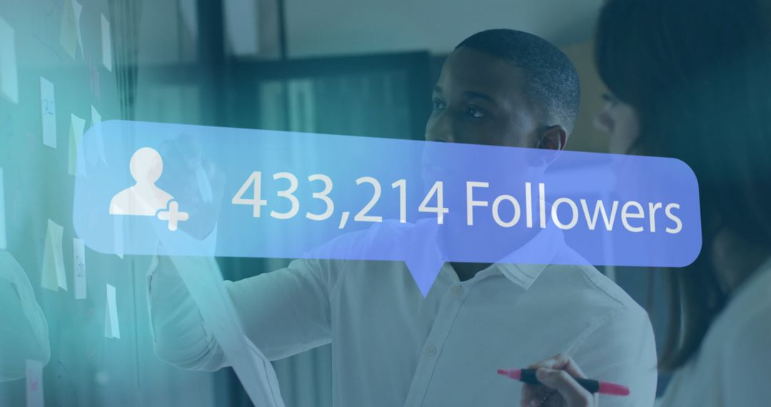 Colleagues Analyzing Follower Metrics on Glass Board in Modern Office