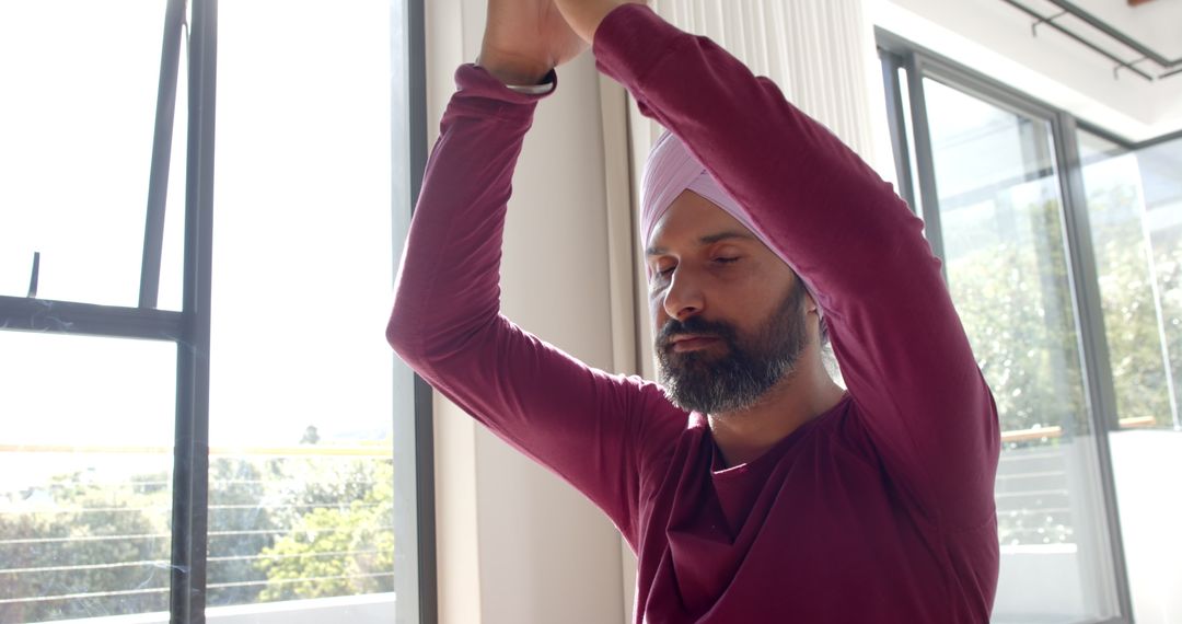 Man in Turban Meditating by Window for Inner Peace