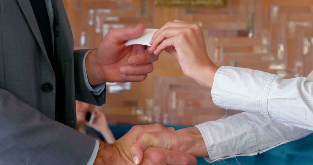 Professional Handshake and Business Card Exchange Between Colleagues - Free Images, Stock Photos and Pictures on Pikwizard.com