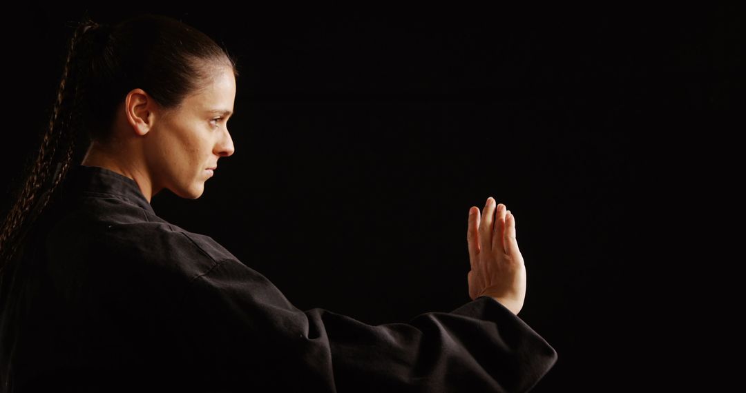 Confident Karate Athlete Striking Intense Pose in Studio