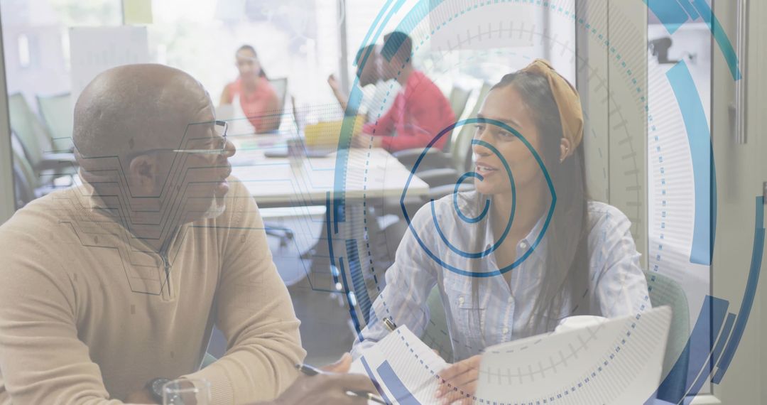 Senior Mentor and Mentee Collaborating in Modern Office