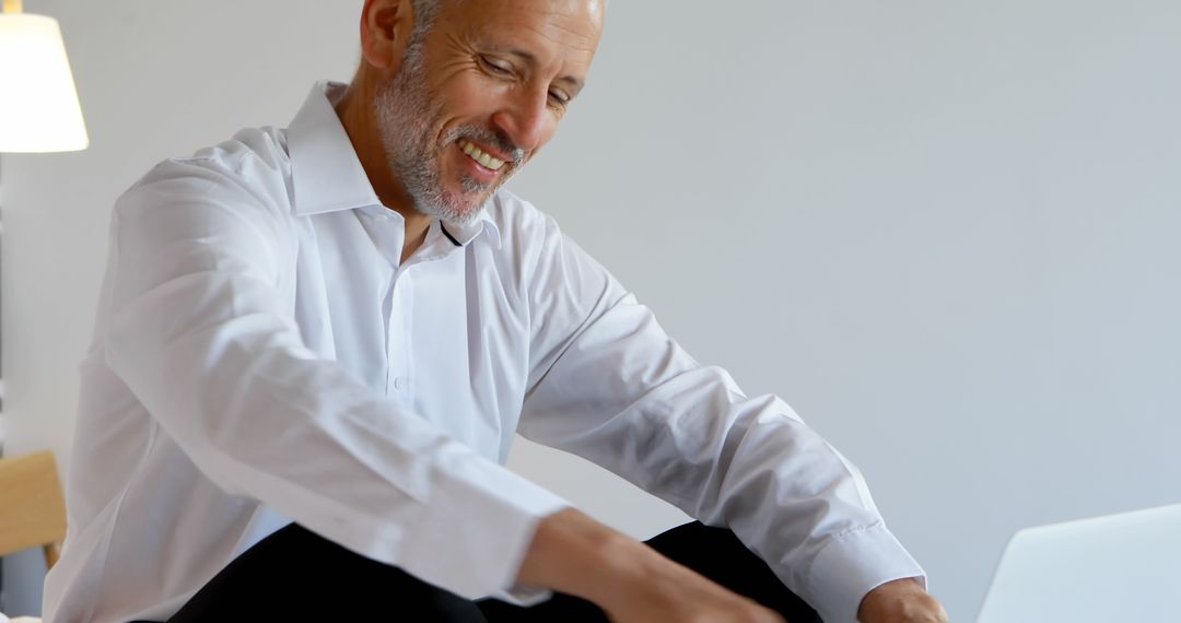 Smiling Mature Man Using Laptop for Work - Free Images, Stock Photos and Pictures on Pikwizard.com