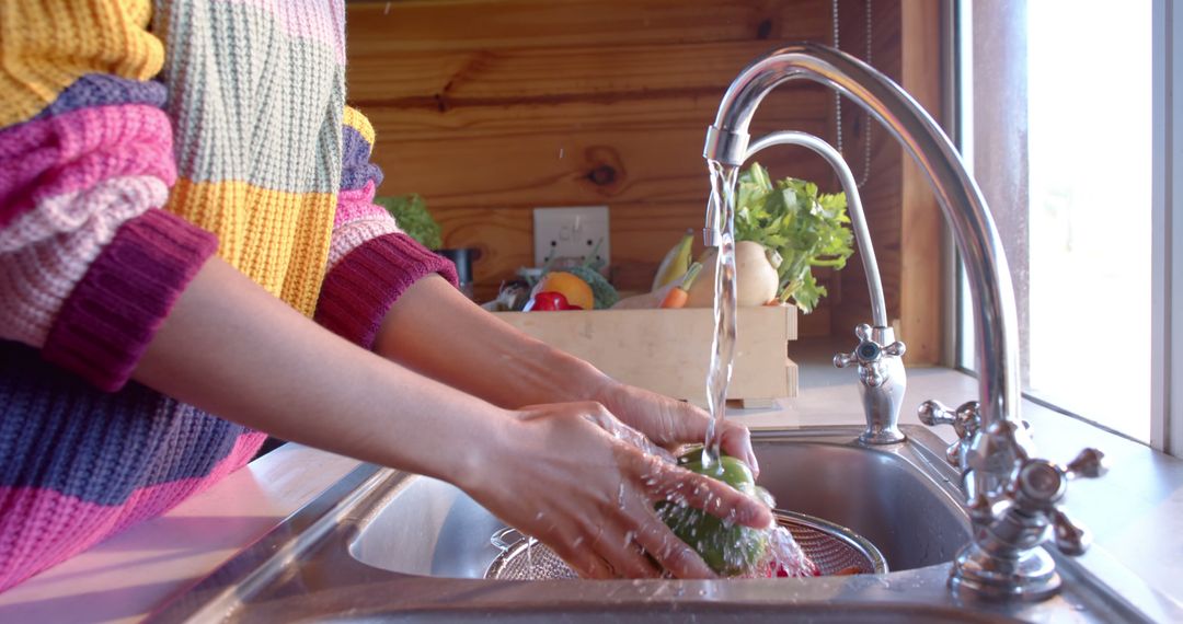 Person Wearing Colorful Sweater Washing Fresh Vegetables in Kitchen Sink - Free Images, Stock Photos and Pictures on Pikwizard.com