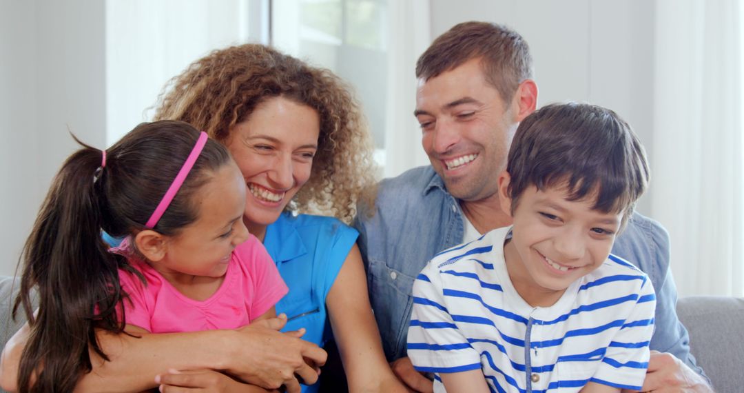 Happy Family Laughing Together in Living Room - Free Images, Stock Photos and Pictures on Pikwizard.com