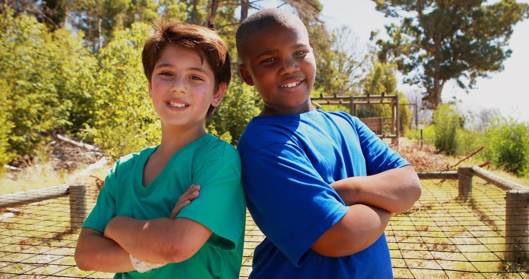 Two Smiling Boys with Arms Crossed Outdoors - Free Images, Stock Photos and Pictures on Pikwizard.com