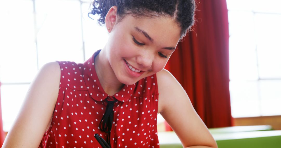 Smiling Student Writing Notes in Classroom - Free Images, Stock Photos and Pictures on Pikwizard.com