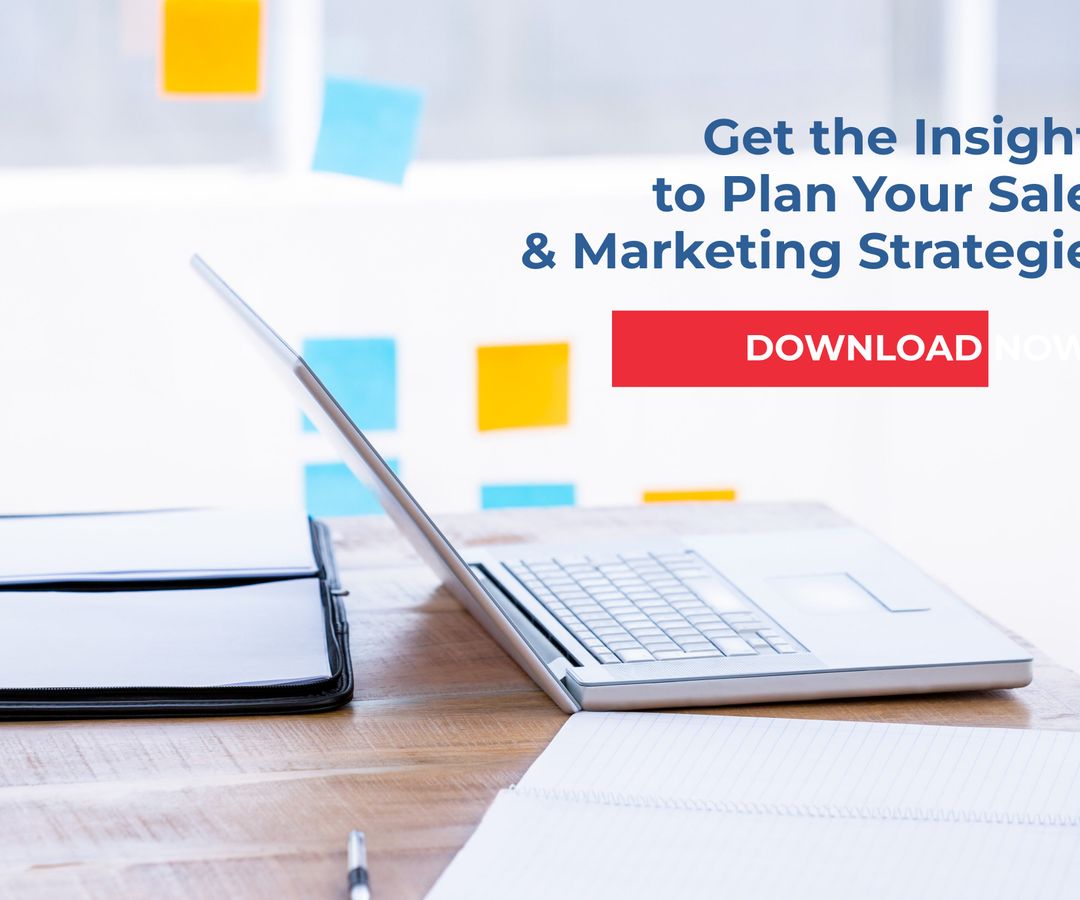 Preparing Sales and Marketing Strategies with Laptop and Documents