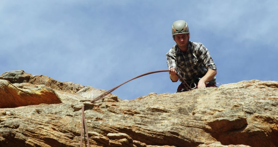 Man Climbing Rocky Cliff with Safety Helmet and Gear - Free Images, Stock Photos and Pictures on Pikwizard.com