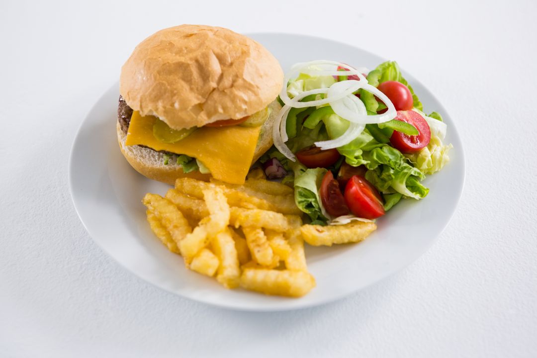 Cheeseburger with French Fries and Fresh Salad on White Plate - Free Images, Stock Photos and Pictures on Pikwizard.com