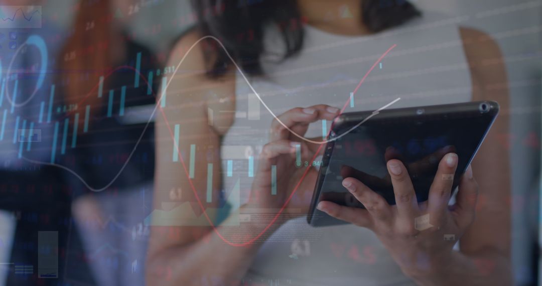 Businesswoman Analyzing Financial Data on Tablet with Graphic Overlay