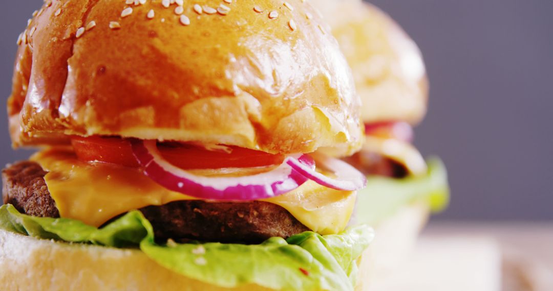 Close-Up of Tasty Cheeseburgers with Lettuce and Tomatoes - Free Images, Stock Photos and Pictures on Pikwizard.com