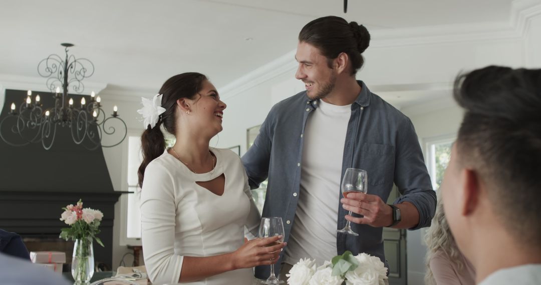 Couple Enjoying Wedding Reception with Drinks and Laughter