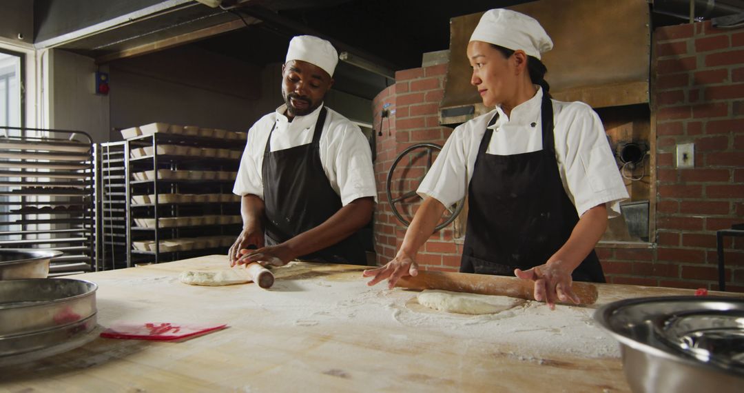 Professional Bakers Kneading Dough in Artisan Bakery - Free Images, Stock Photos and Pictures on Pikwizard.com