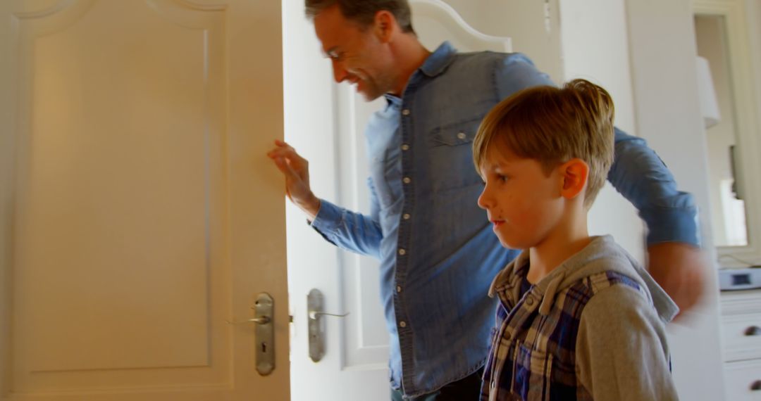 Father and Son Entering Room with Smiles - Free Images, Stock Photos and Pictures on Pikwizard.com