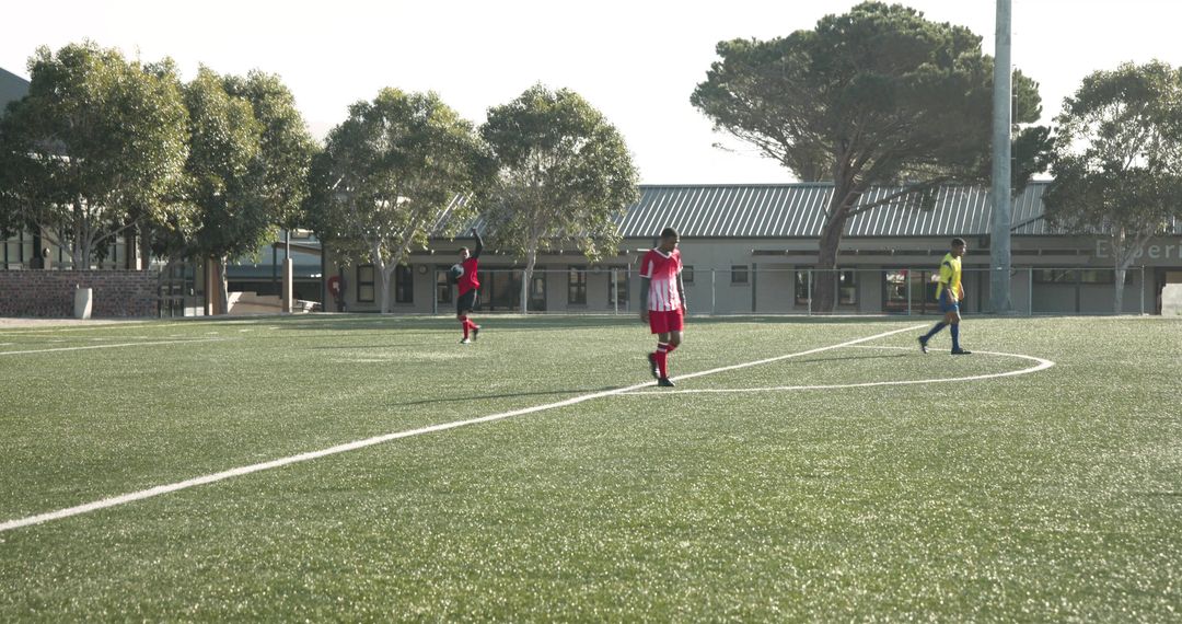 Soccer Player Strolling During Game Near School Arena