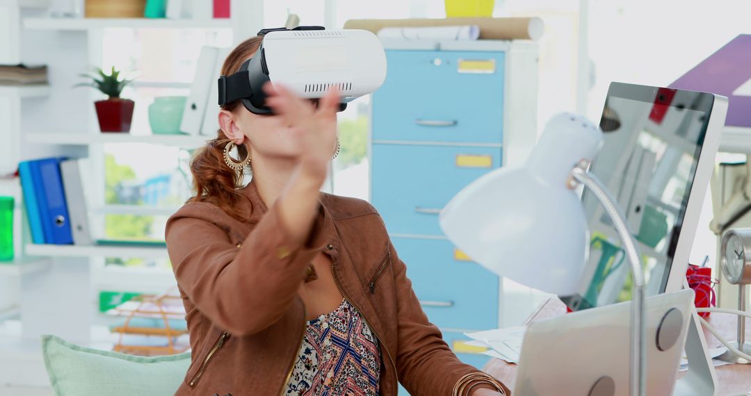 Woman Experiencing Virtual Reality at Office Desk - Free Images, Stock Photos and Pictures on Pikwizard.com