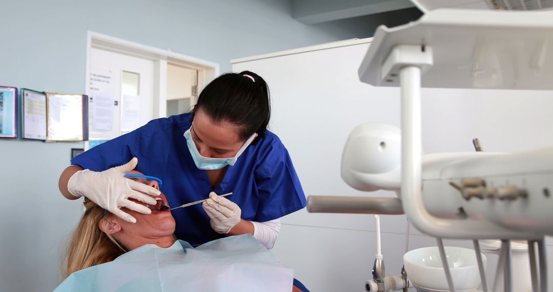 Dentist Examining Patient with Dental Tools in Modern Clinic - Free Images, Stock Photos and Pictures on Pikwizard.com