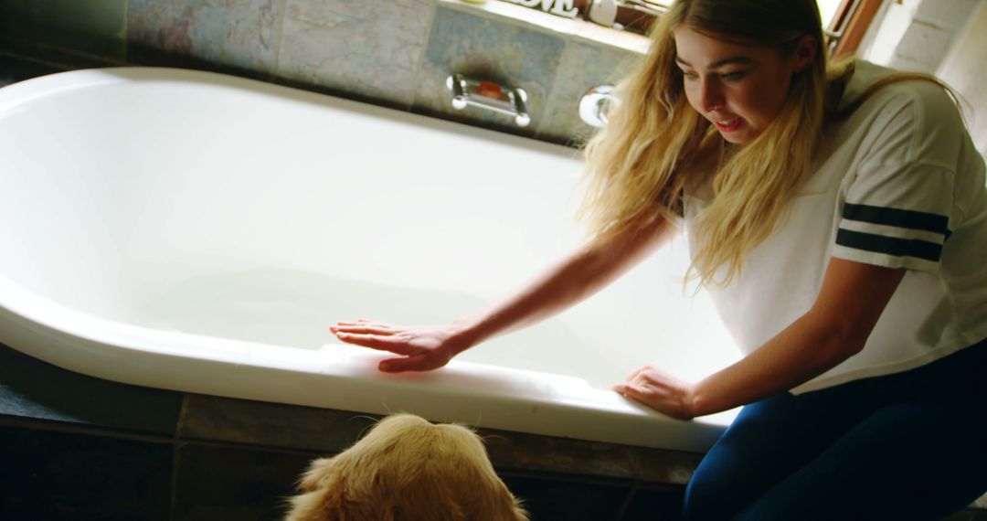 Young Woman Preparing Bath for Golden Retriever - Free Images, Stock Photos and Pictures on Pikwizard.com