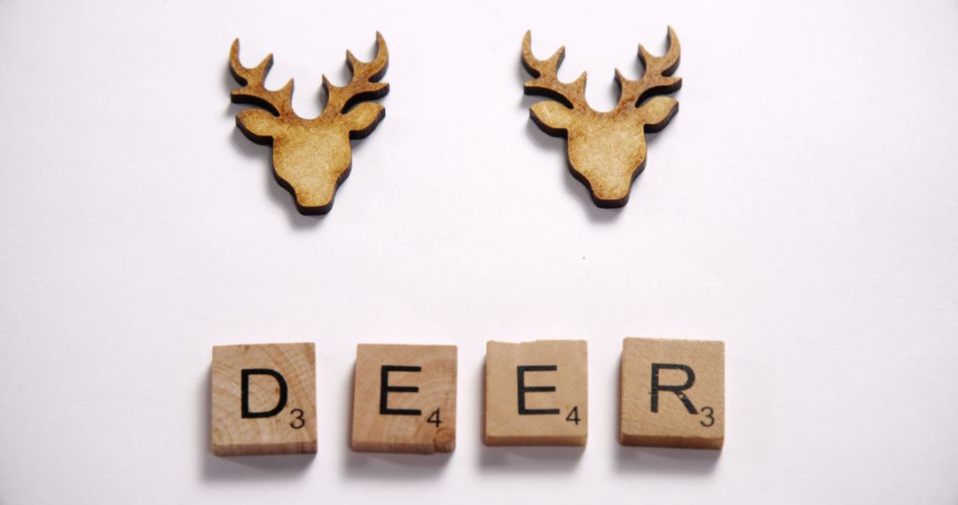 Minimalist Wooden Deer Sculptures with Scrabble Letters - Free Images, Stock Photos and Pictures on Pikwizard.com