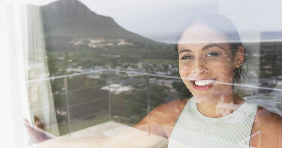 Smiling Woman Standing by Window with Scenic View of Mountain - Free Images, Stock Photos and Pictures on Pikwizard.com