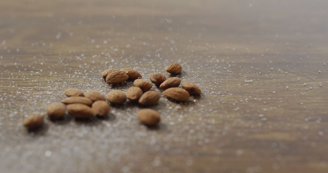 Scattered Almonds on Rustic Wooden Table Surface