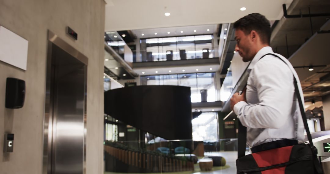 Business Professional Holding Bag in Modern Office Lobby