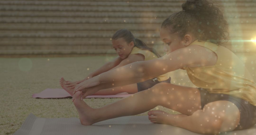 Young Girls Stretching Together During Outdoor Exercise Class - Free Images, Stock Photos and Pictures on Pikwizard.com