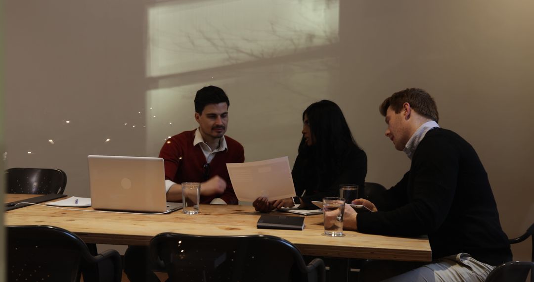 Colleagues Collaborating in Informal Office Meeting with Technology