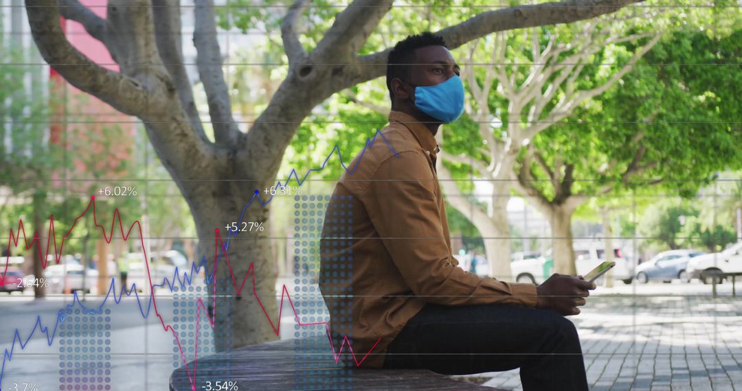 Man in Urban Park Analyzing Financial Data on Smartphone
