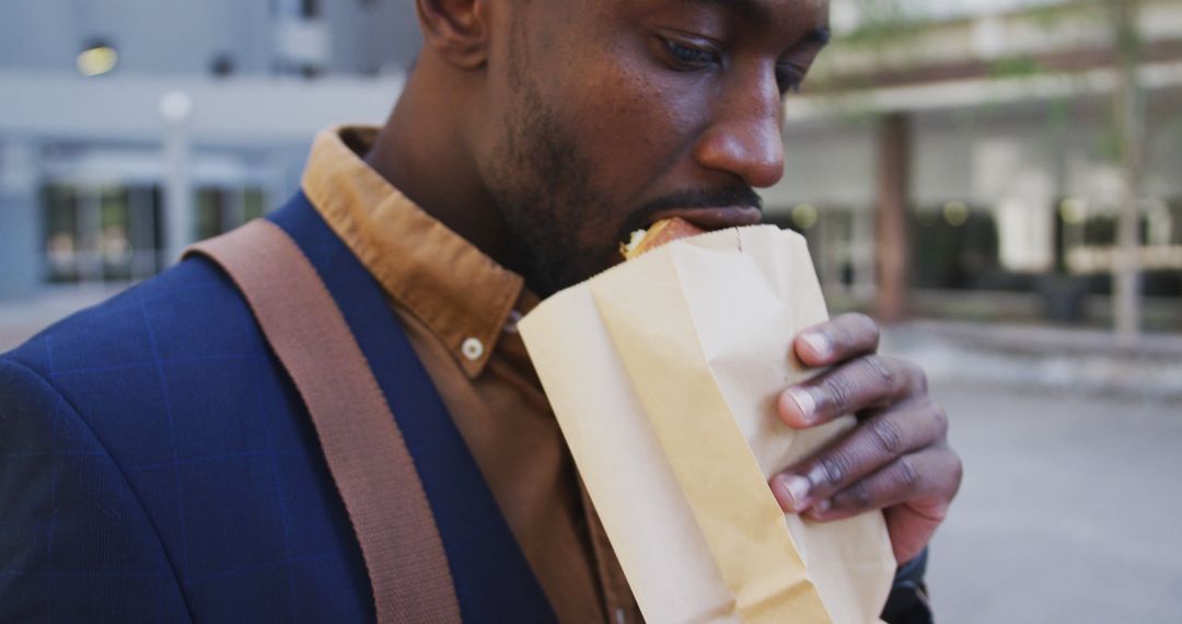 Man Eating Sandwich Outdoors During Lunch Break - Free Images, Stock Photos and Pictures on Pikwizard.com