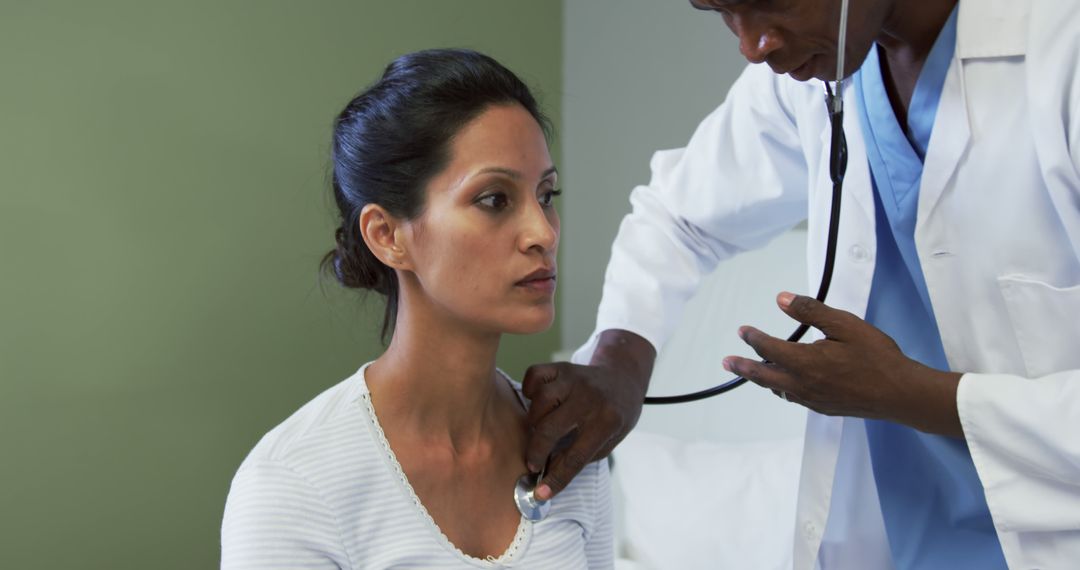 Doctor Examining Female Patient with Stethoscope in Medical Facility - Free Images, Stock Photos and Pictures on Pikwizard.com