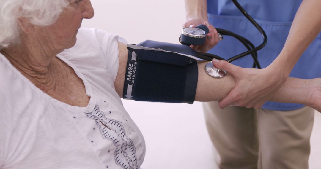 Nurse Checking Blood Pressure of Elderly Woman - Free Images, Stock Photos and Pictures on Pikwizard.com