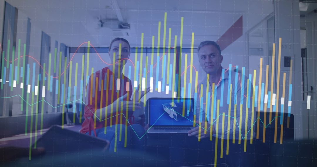 Business Partners Analyzing Digital Financial Graphs on Laptop and Smartphone